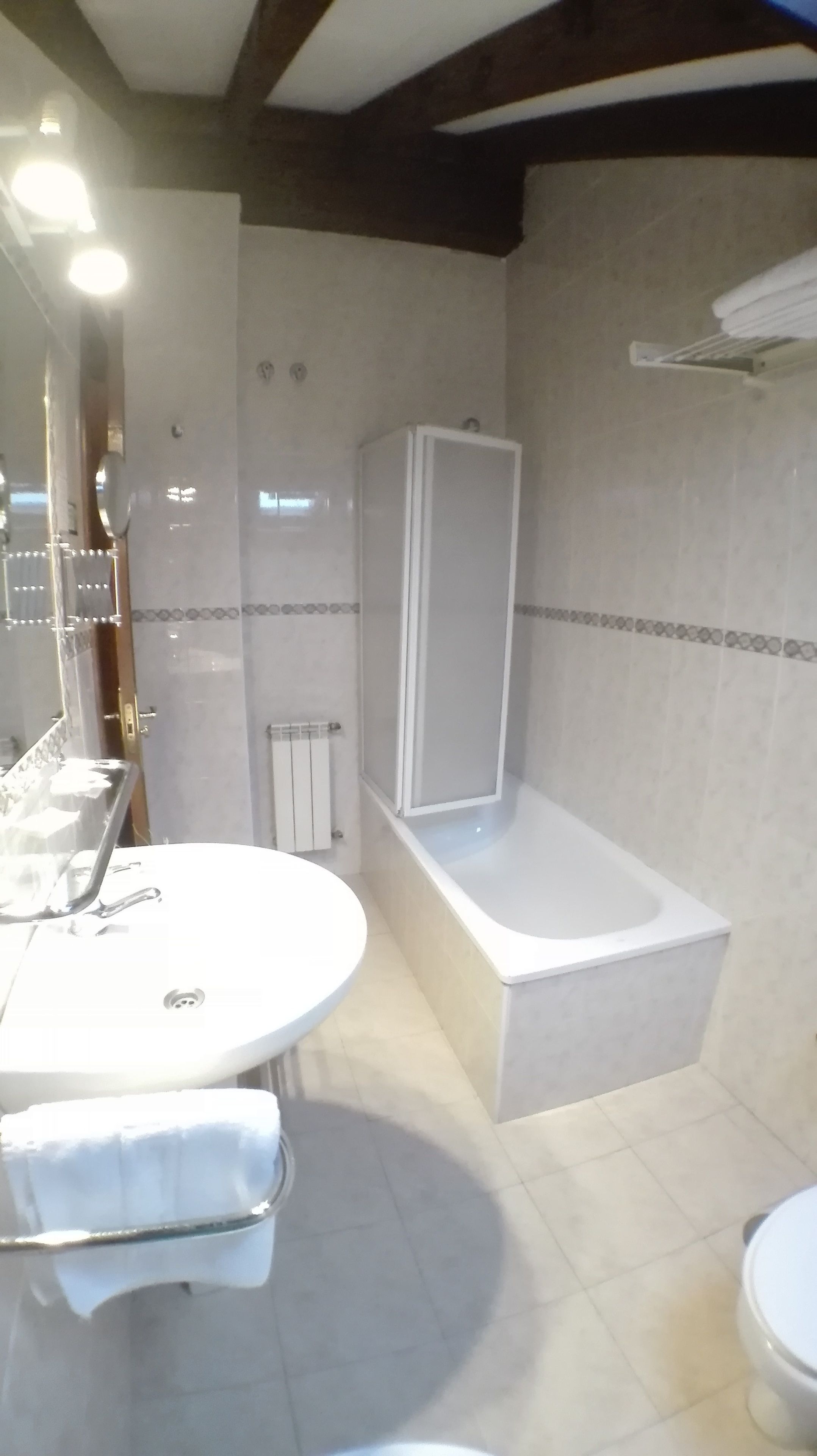 A bathroom with a bathtub, a sink, and a toilet.