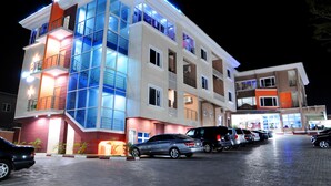 A multi-story hotel with a modern design, featuring balconies and large windows.
