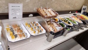 A buffet with various dishes including sushi, bread, and salads. - Toyoko Inn Osaka Semba Higashi (Osaka)