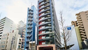 A hotel with multiple floors, balconies, and a sign indicating it is a hotel. - Toyoko Inn Osaka Semba Higashi (Osaka)