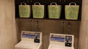 Two coin-operated laundry machines with digital displays, each with a water level indicator and a coin slot. - Toyoko Inn Shin Yokohama Station Shinkan (Yokohama)