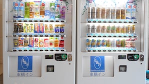 Two vending machines stocked with beverages and snacks, each with a payment interface and a logo for toyoko-inn.com. - Toyoko Inn Shonan Hiratsuka Station Kita 1 (Hiratsuka)