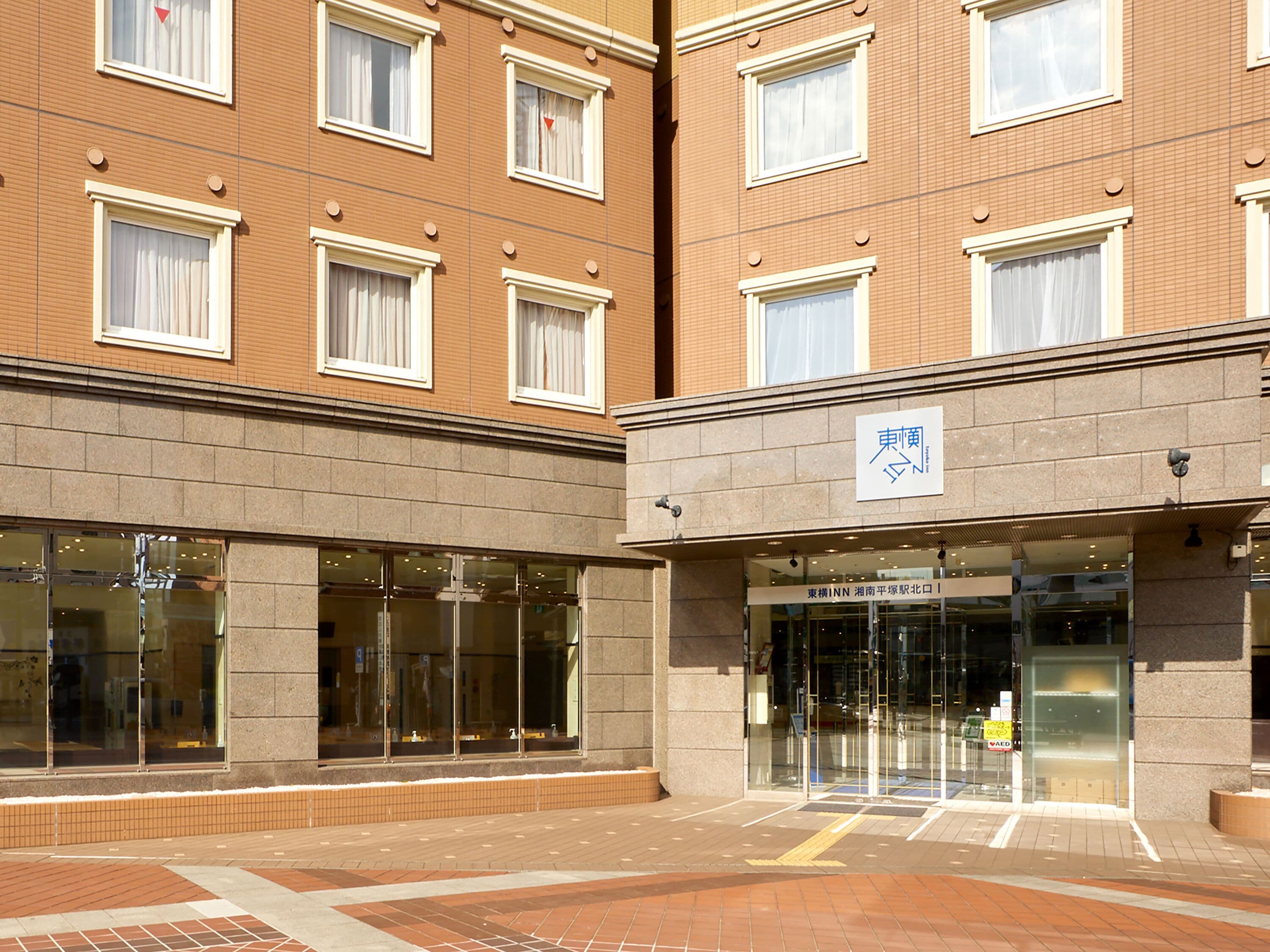 A hotel entrance with a glass door and a sign above it.