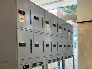 A row of grey utility cabinets with numbered labels, each containing a switch and a label plate. - Toyoko Inn Tokyo Fussa Station Higashi (Fussa)