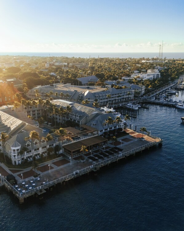 An aerial view of a coastal hotel with multiple buildings, a marina, and a pier extending into the water. - Opal Key Resort & Marina, Key West (Key West)