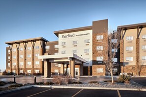 A Fairfield by Marriott hotel with a modern design, featuring a covered entrance and multiple floors.