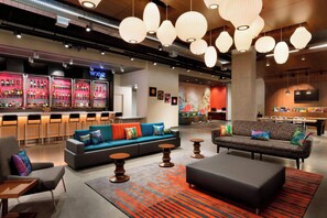 A modern lounge area with sofas, a bar, and a pool table. - Aloft by Marriott Hillsboro-Beaverton (Hillsboro)