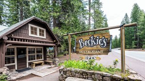 A rustic wooden building with a signboard for 'Bock's Restaurant' indicating it's open. - Union Creek Resort (Prospect)