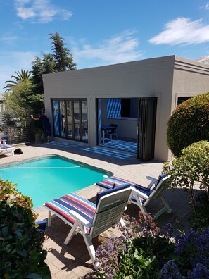 Una piscina al aire libre, tumbonas