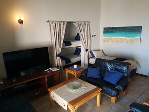 Family Apartment, 2 Bedrooms | Living room | 55-inch TV with digital channels