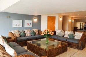 Relax in a stylish living area with a comfortable sofa, coffee table, and framed artworks.