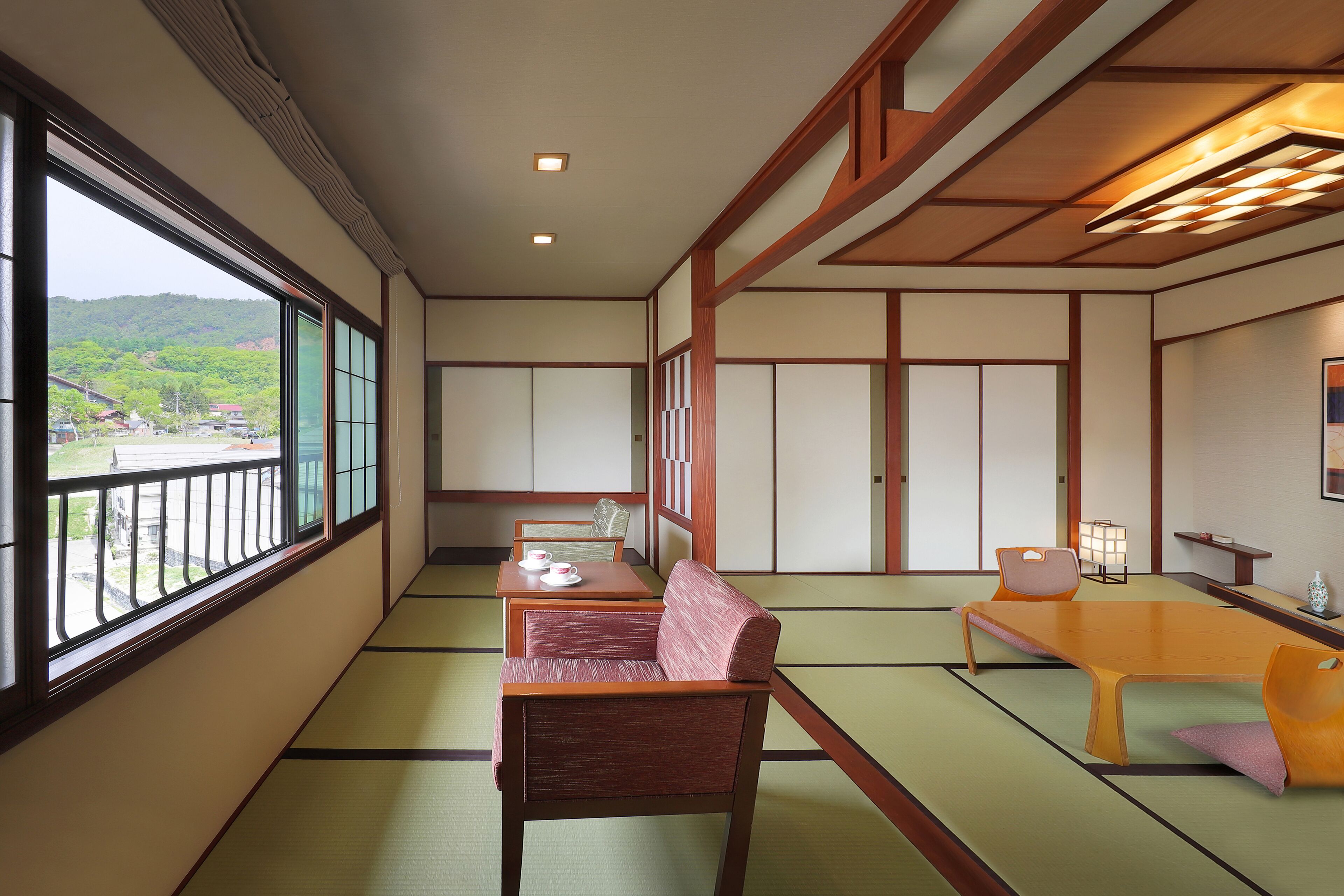 A traditional Japanese room with tatami flooring, a low table, and seating.