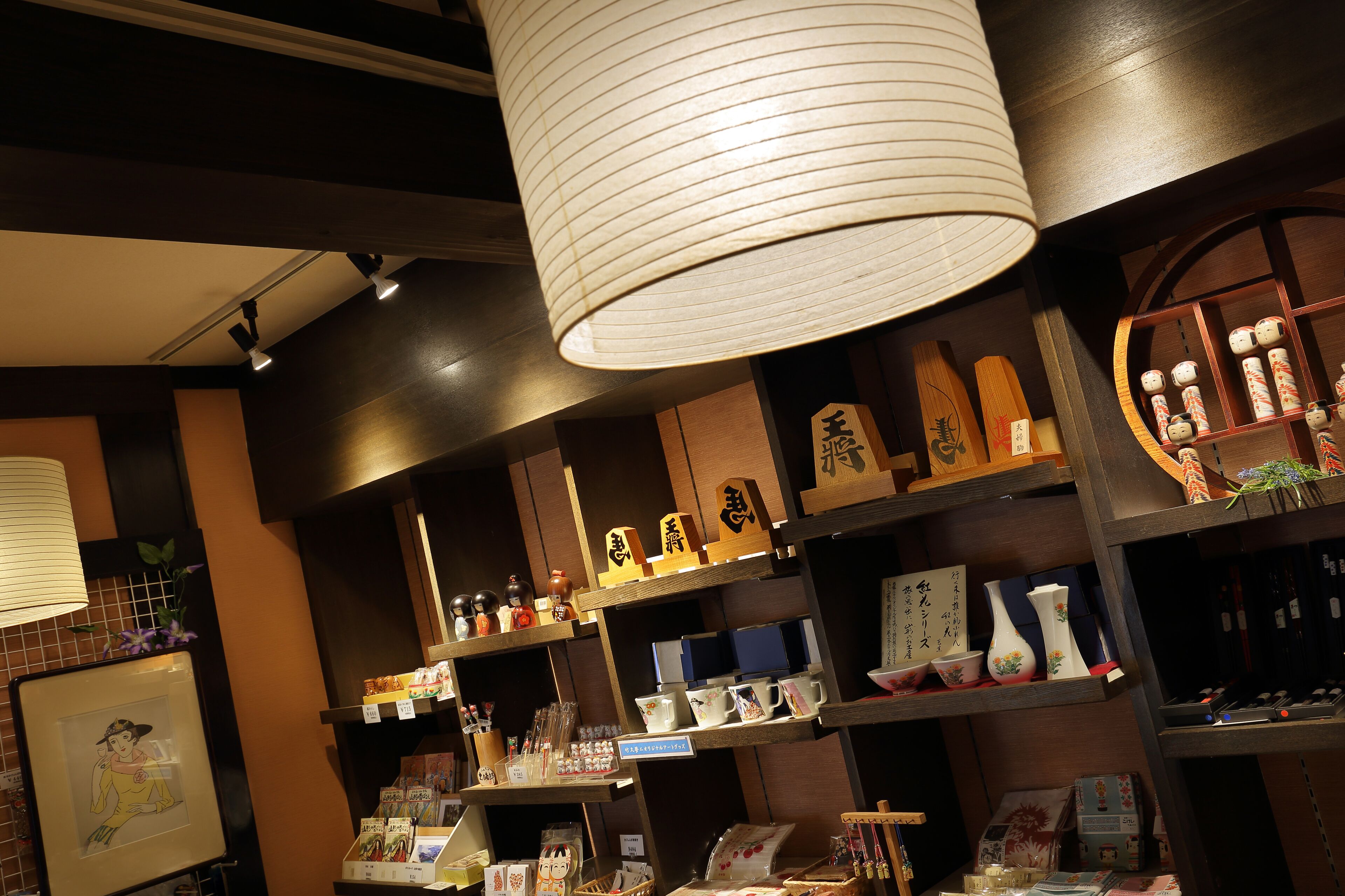 A traditional Japanese store with shelves of ceramics and decorative items.