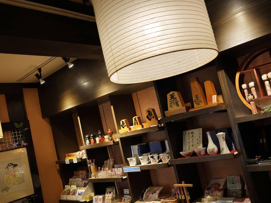 A traditional Japanese store with shelves of ceramics and decorative items.