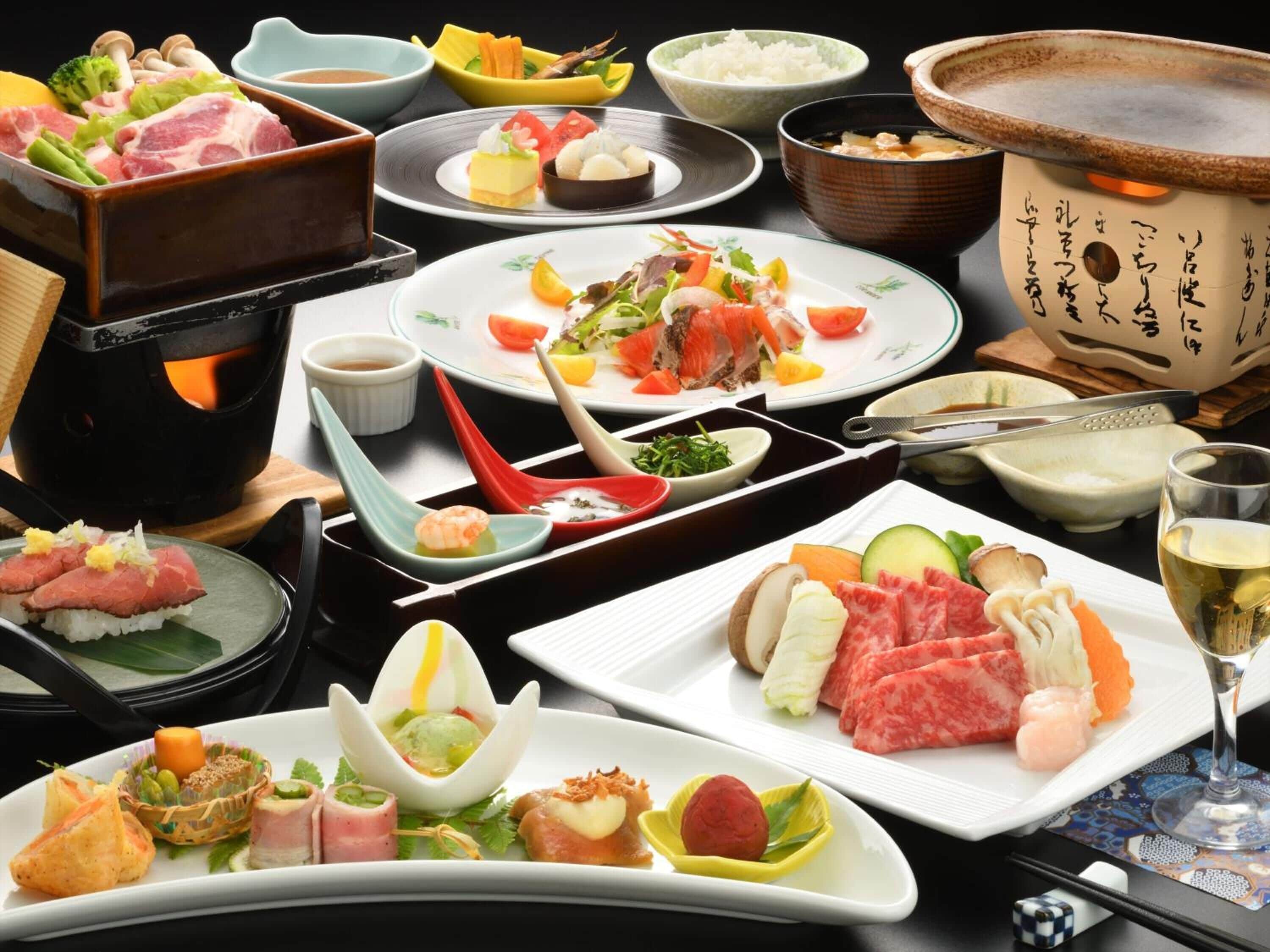 A variety of Japanese dishes including sushi, sashimi, and tempura, served on traditional ceramic plates and bowls.
