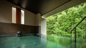 A spacious indoor swimming pool with a view of lush greenery outside. - Zao Onsen Zao Shiki No Hotel (Yamagata)