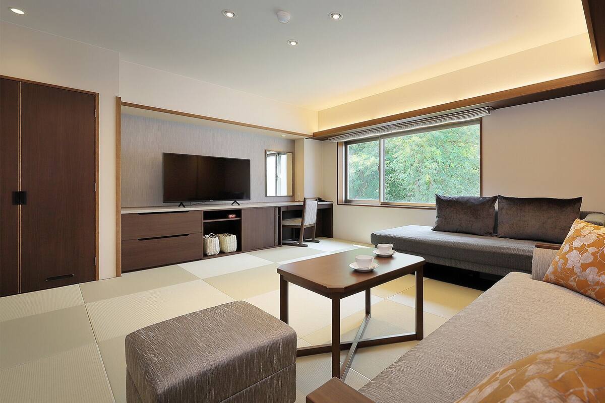 A modern living room with a sofa, coffee table, and TV.