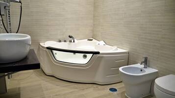 Suite, Hot Tub | Bathroom | Free toiletries, hair dryer, towels