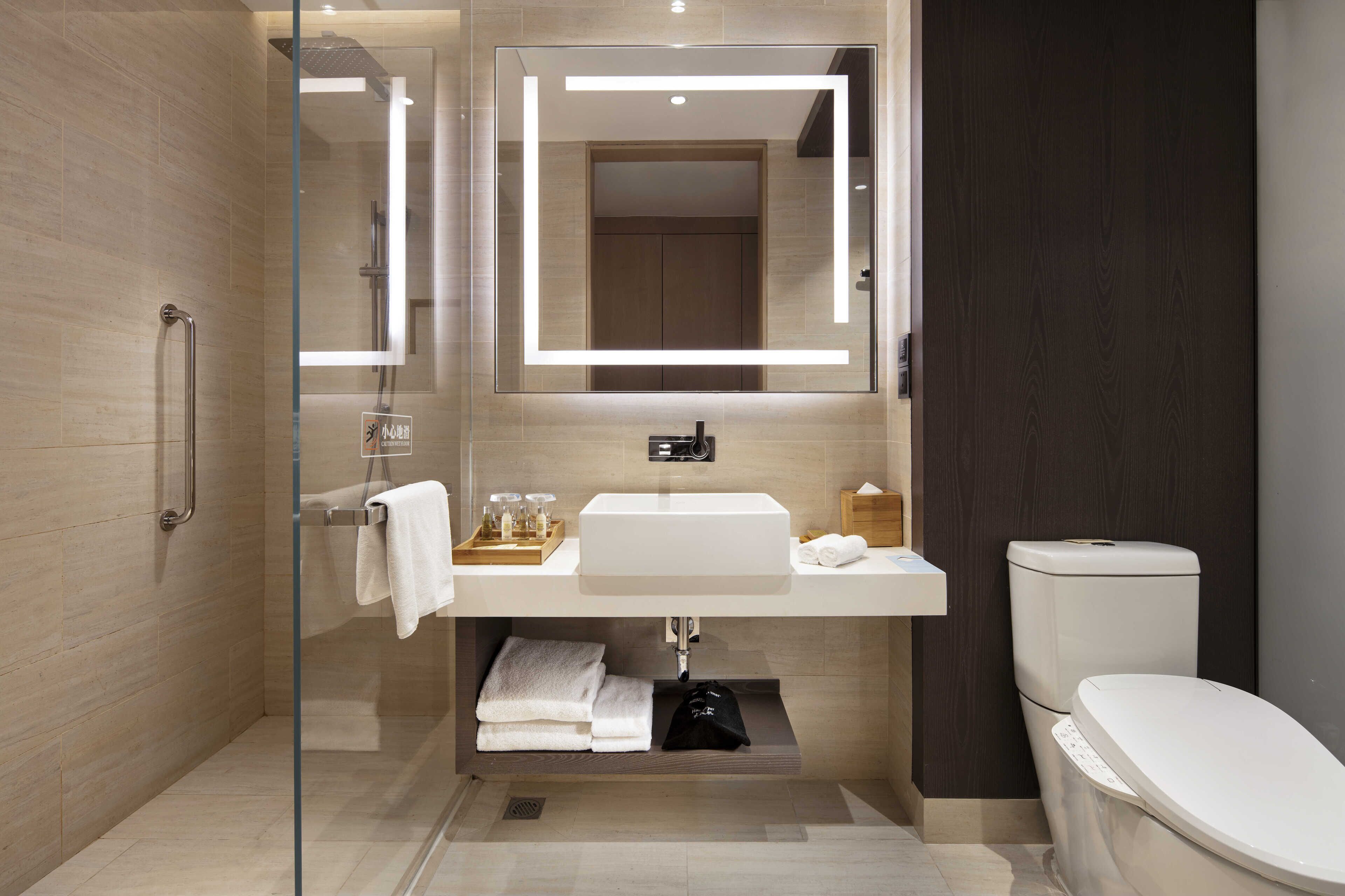 rainfall showerhead, designer toiletries, hair dryer, slippers