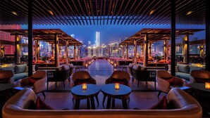 A rooftop bar with a city view, featuring multiple seating areas and tables. - Regent Chongqing (Chongqing)
