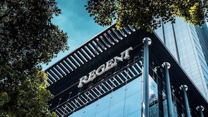 A building with a prominent 'REGENT' sign, tall glass windows, and a metal structure. - Regent Chongqing (Chongqing)