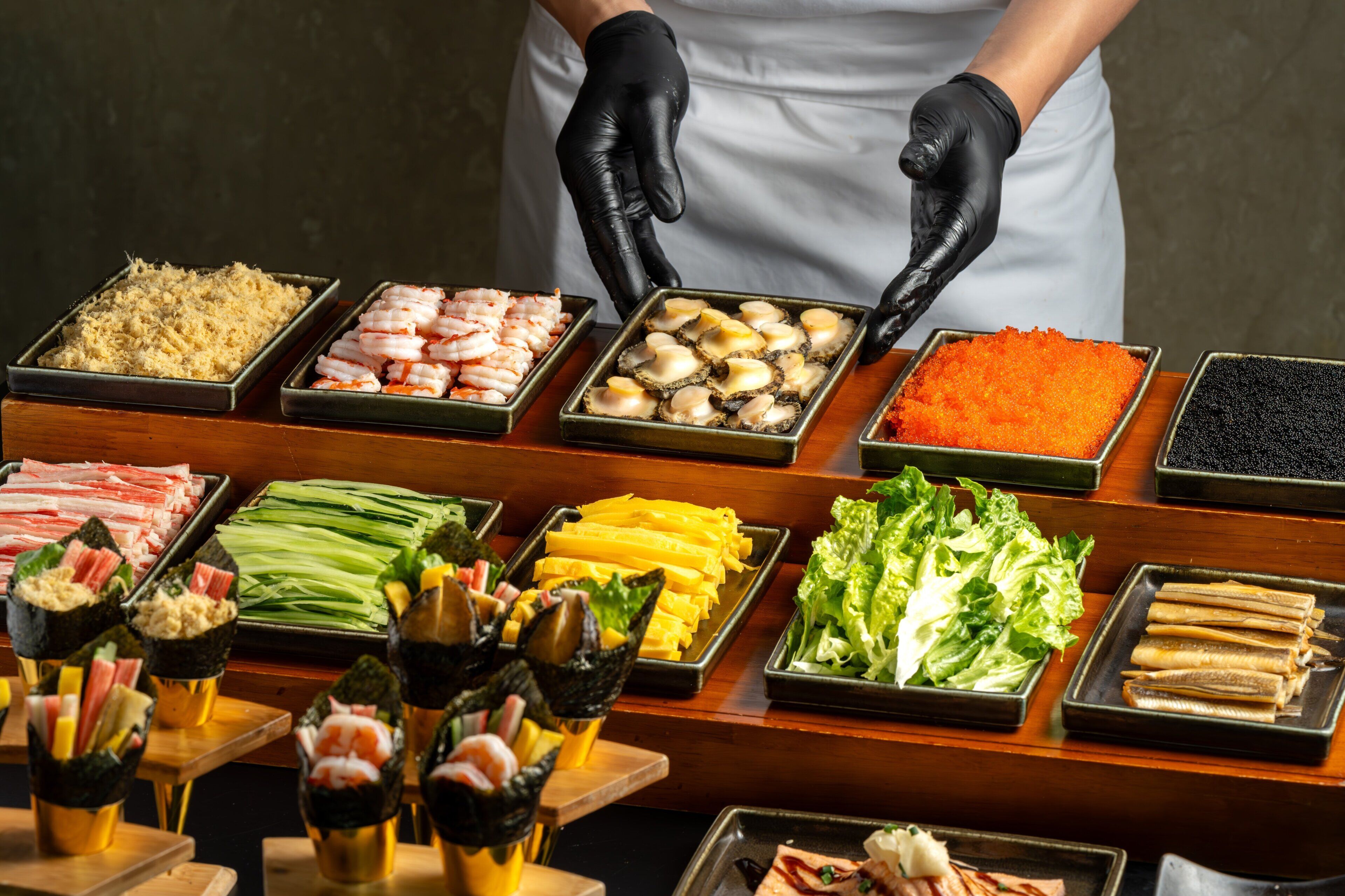 A buffet with various food items including seafood, vegetables, and other dishes.