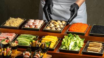 A buffet with various food items including seafood, vegetables, and other dishes.
