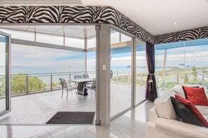 Executive Penthouse, 3 Bedrooms, Ocean View | Living area | 50-inch flat-screen TV with digital channels, TV, DVD player - Spinnakers by Rockingham Apartments (Rockingham)