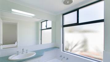 Separate bathtub and shower, hair dryer, towels