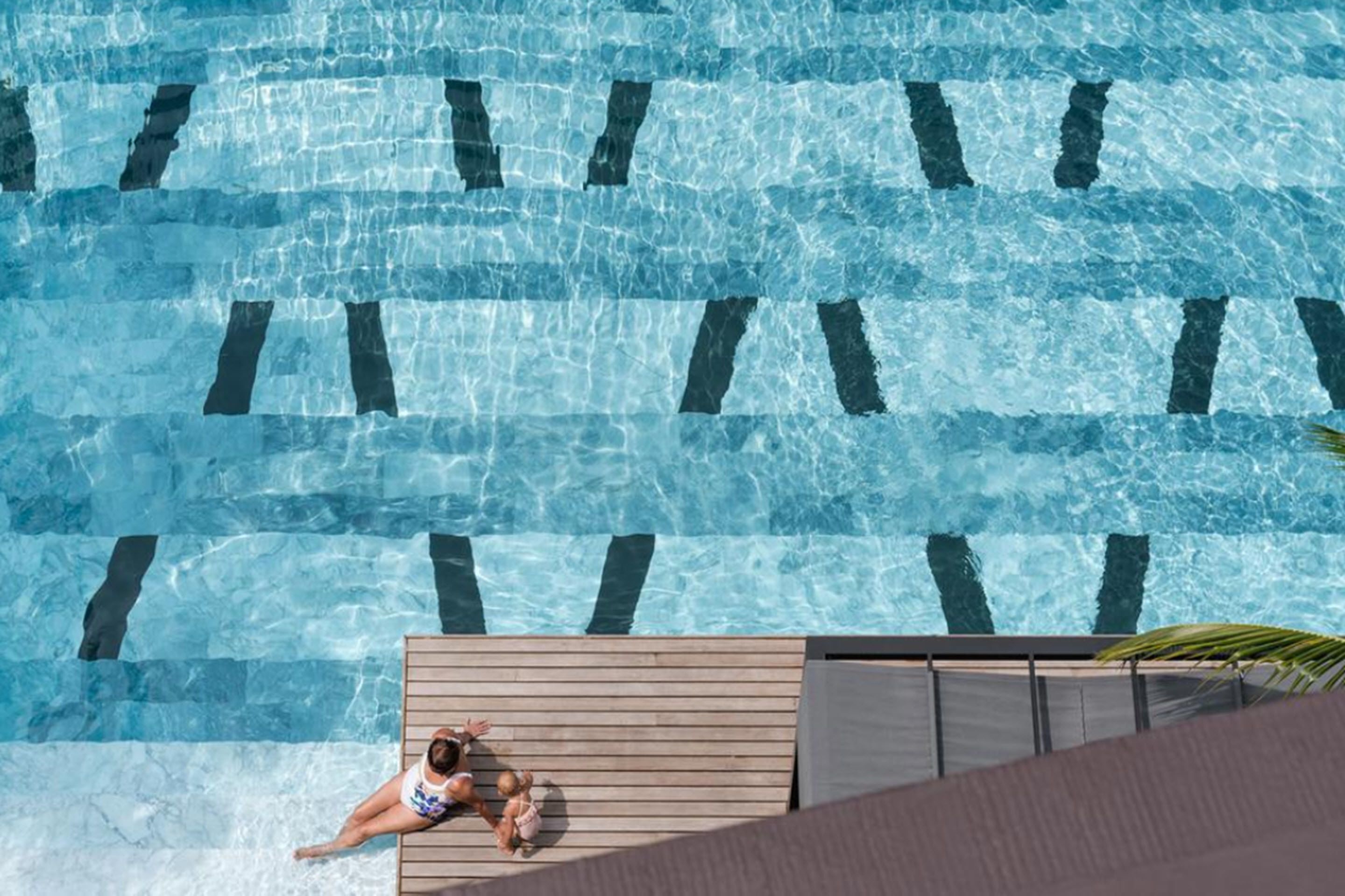 A swimming pool with clear water and lane markings.