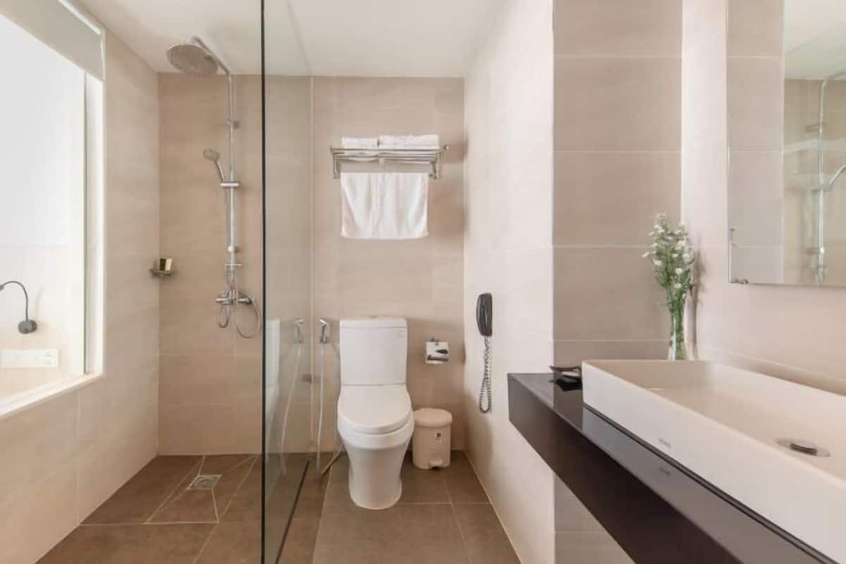 Designer toiletries, hair dryer, slippers, towels