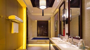 A modern bathroom with a large mirror, dual sinks, and a bench. - Huaqing Aegean Inter Hot Spring Resort (Xi'an)