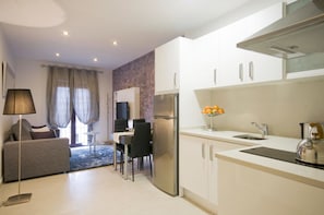 Apartamento, 1 quarto | Área de estar | TV de tela plana