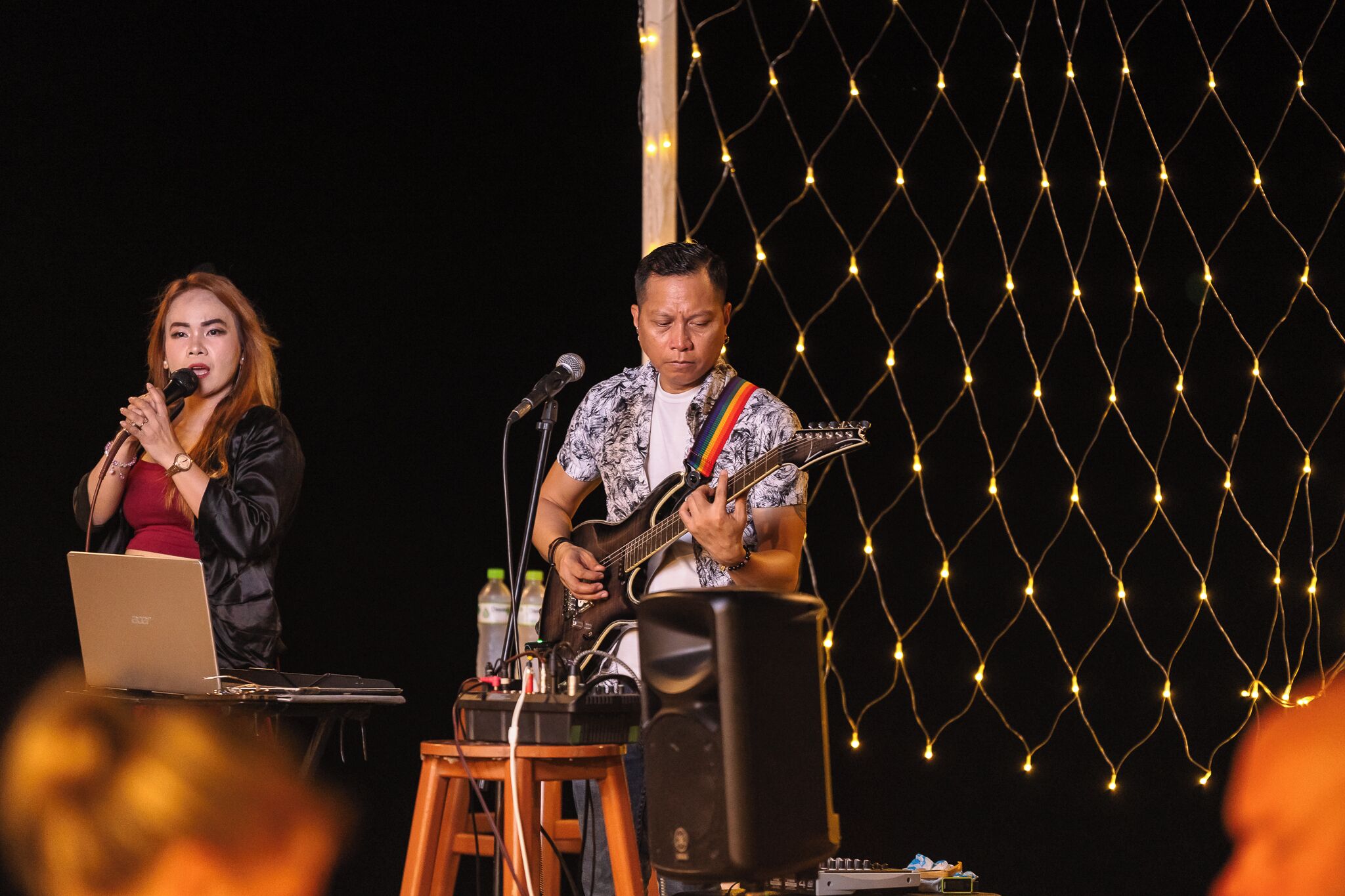 A stage with a laptop, a microphone, and a speaker.