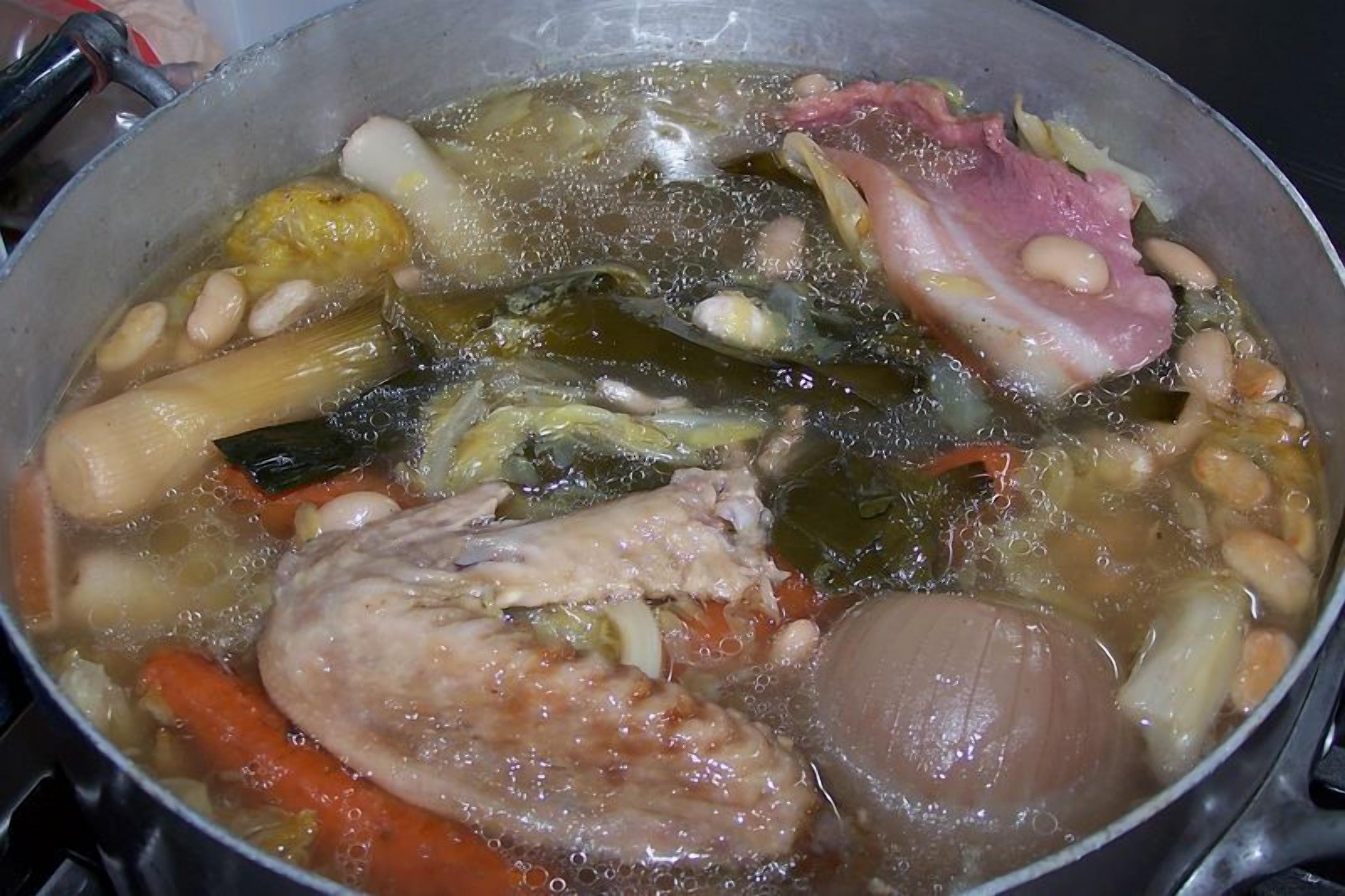 A pot of stew with various vegetables and meat.