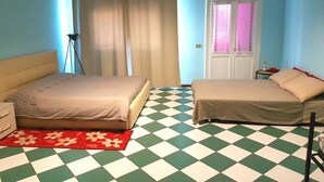 A room with two beds, a floor lamp, a window with curtains, and a checkered floor. - Nightstars B&B (Mestre)