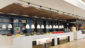 A modern kitchen with white countertops, hanging pendant lights, and neatly arranged kitchenware. - INNSiDE by Meliá Zhengzhou (Zhengzhou)