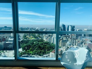 A high-rise building with a view of a cityscape and a body of water. - Top Rentals Downtown (Buenos Aires)