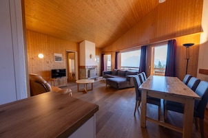 Family Apartment, 3 Bedrooms | Living area | 80-inch flat-screen TV with cable channels