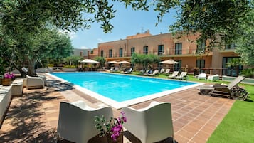 Piscina a l'aire lliure de temporada, para-sols i gandules