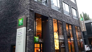 A modern hotel with a brick facade, large windows, and a sign indicating it is part of the ibis Styles hotel chain. - Ibis Styles Tbilisi Center (Tbilisi)