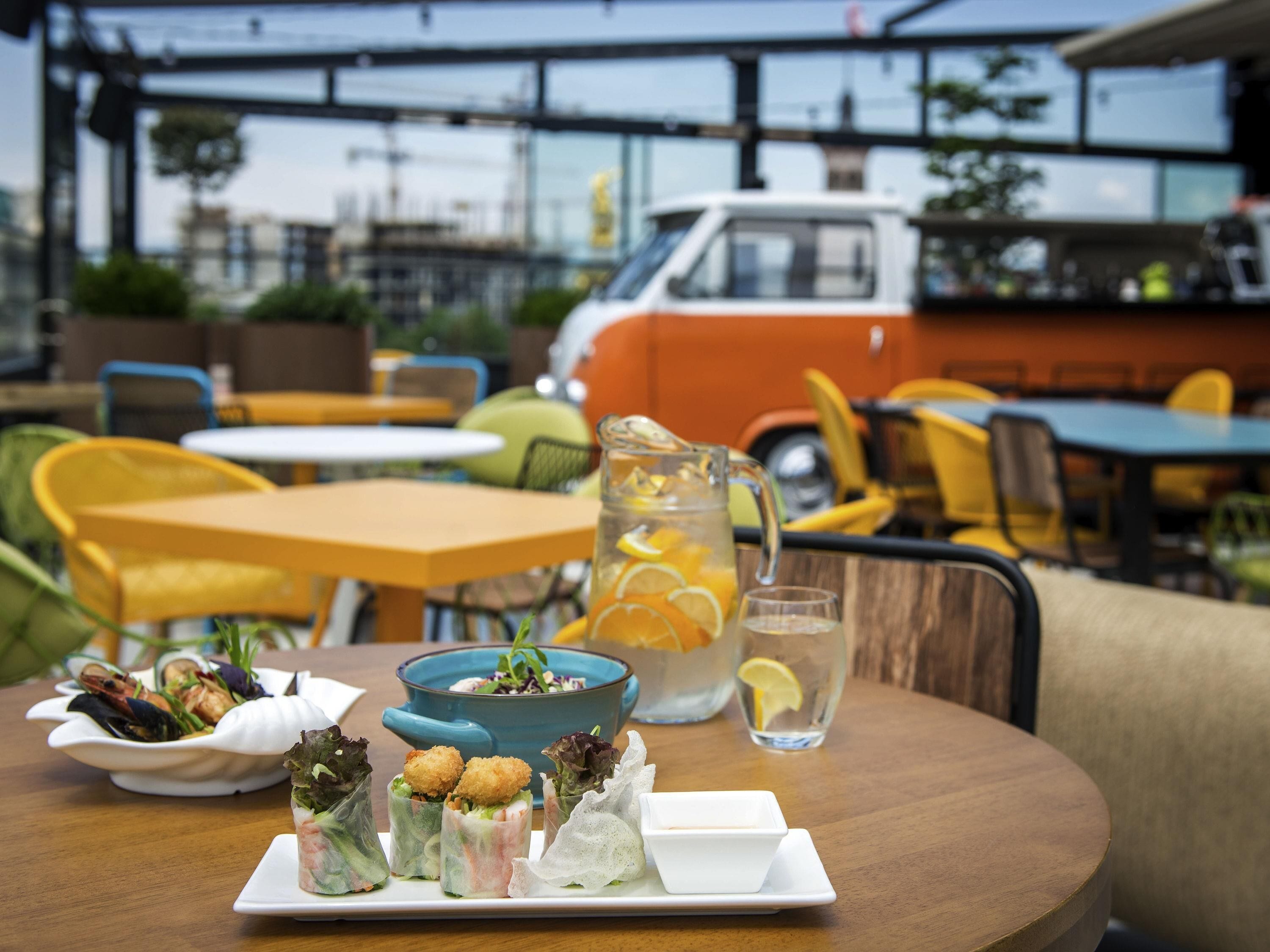 A table with food, a pitcher, and a glass.