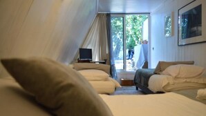 A bedroom with two beds, a TV, and a large window. - Casa Marta : Suites - Terrasses et vue Panoramique (Tournon-sur-Rhone)