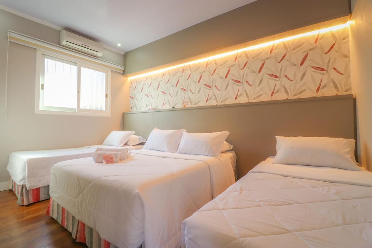 Deluxe Quadruple Room | Minibar, desk, blackout curtains, iron/ironing board