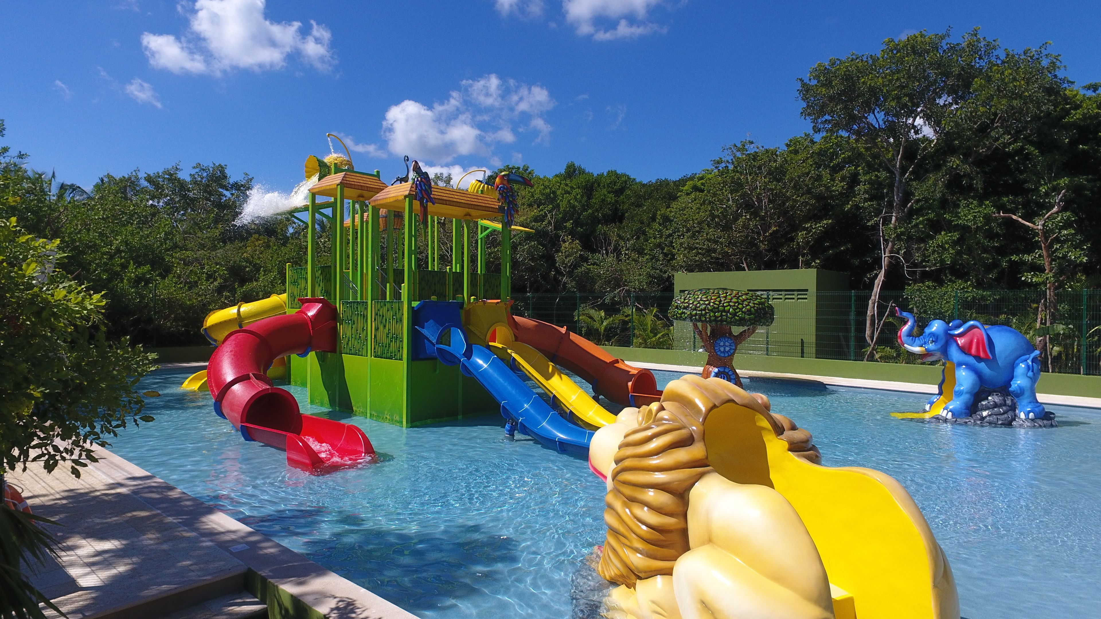 A water park with multiple slides and a pool.
