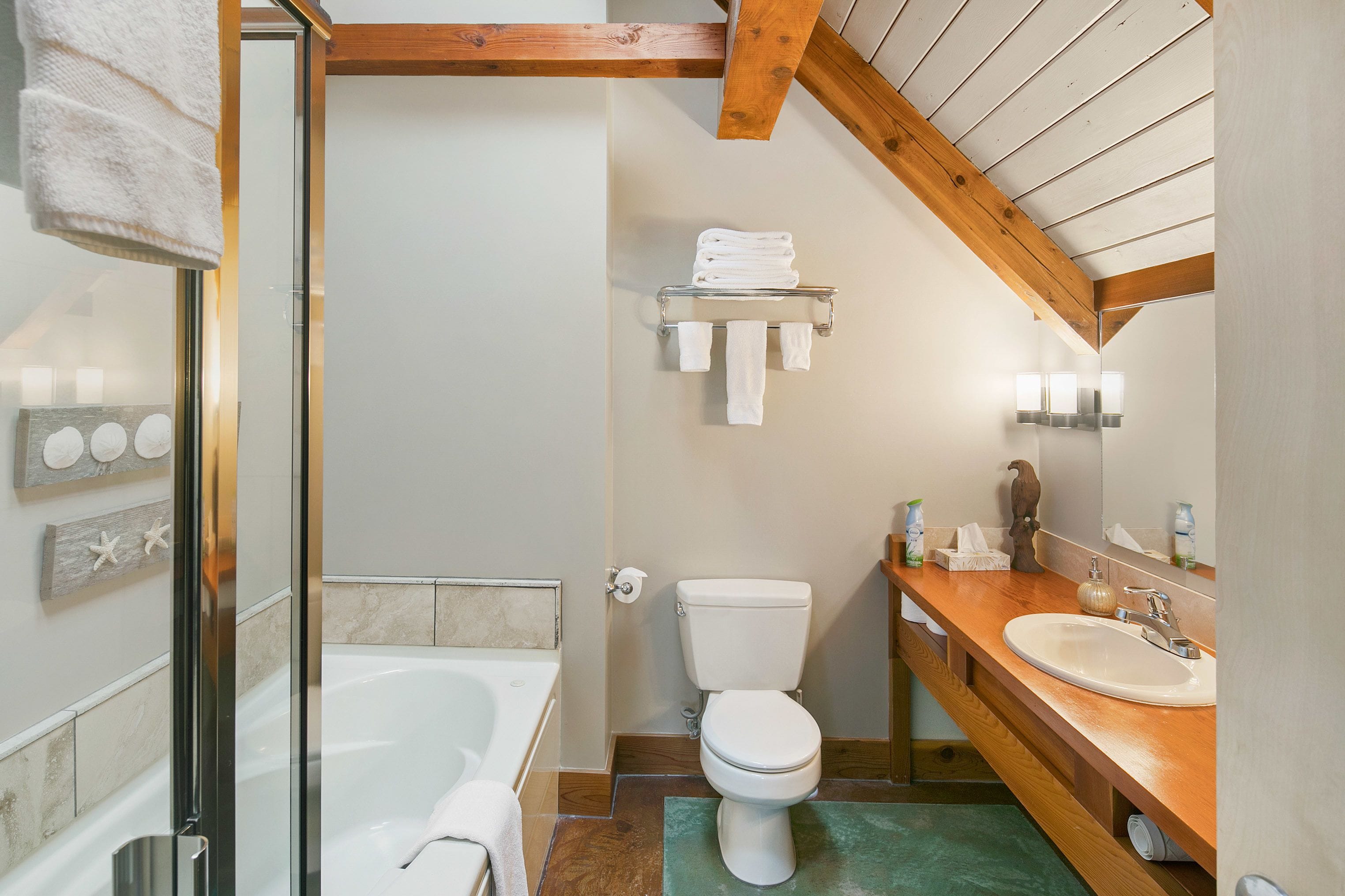 A bathroom with a bathtub, toilet, and sink.