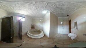 A bathroom with a glass shower enclosure, a freestanding bathtub, and a pedestal sink. - Pousada Parque Praia (Penha)