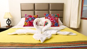 A hotel room with a bed, two pillows, a nightstand, a lamp, and a window with curtains. - Hotel Mica (Abancay)