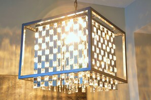 A chandelier with multiple square light fixtures. - Monki-Di Executive Suites - Alura (Calgary)