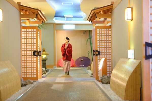 A traditional Japanese interior with tatami mats, shoji screens, and a person in a red kimono. - Awanoyu (Matsumoto)
